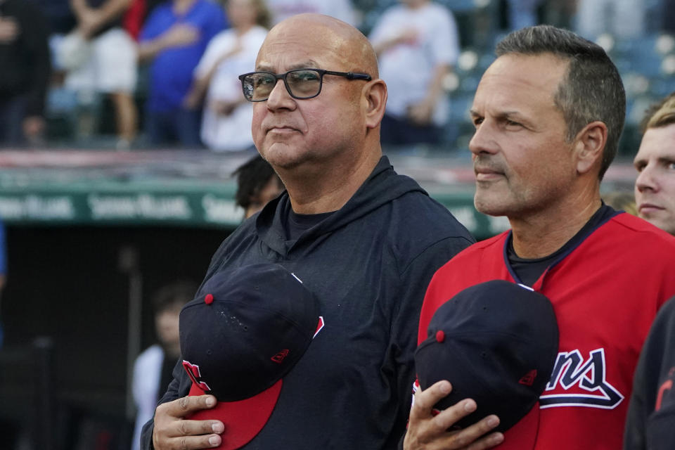 Cleveland Guardians manager Terry Francona, left, stands for the national anthem next to third base coach Mike Sarbaugh, right, before the team's baseball game against the Los Angeles Dodgers, Tuesday, Aug. 22, 2023, in Cleveland. (AP Photo/Sue Ogrocki)
