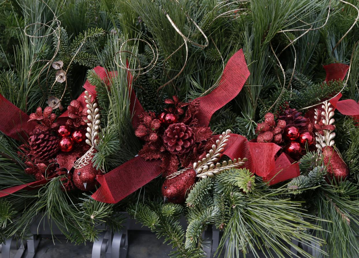 Workers in a greenhouse create wreaths, baskets and holiday arrangements at Timbuk Farms in Granville, Oh., on Tuesday, November 16, 2021. The 300-acre farm is busy fulfilling wholesale orders and preparing to host families when the farm opens to the public the day after Thanksgiving.