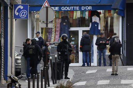 French police and special BRI brigade police secure the area after a man was shot dead outside a police station in the 18th district in Paris, France, January 7, 2016. REUTERS/Benoit Tessier