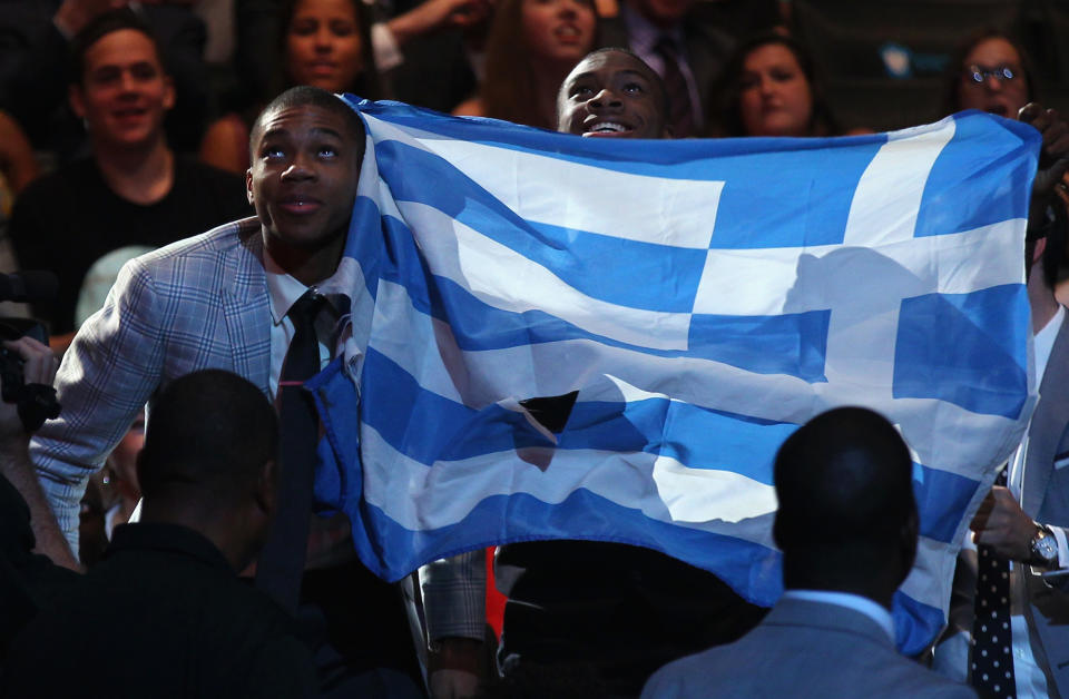 Giannis Antetokounmpo stand by the Greek flag during the 2013 NBA draft. (Mike Stobe/Getty Images)