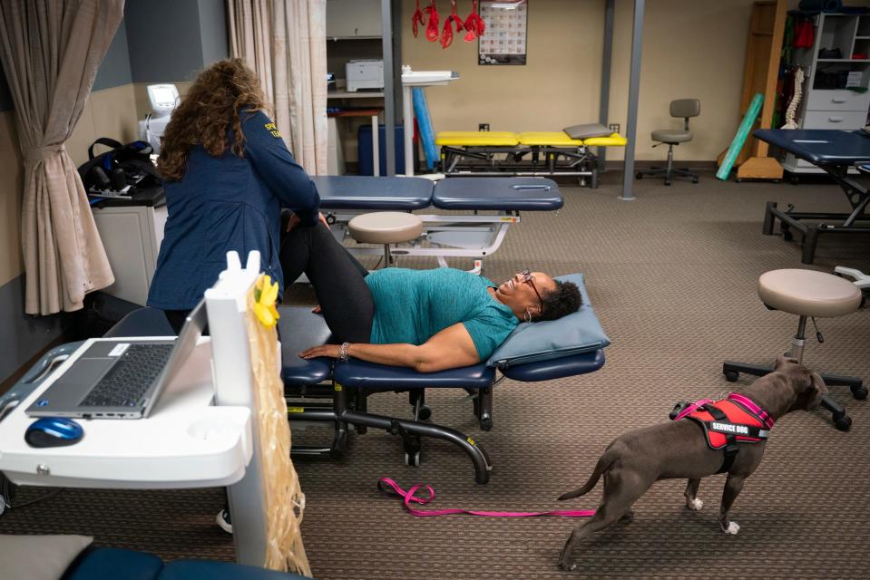 Physical therapy assistant Jessie Hadley, 52, of Ann Arbor, stretches Tonya Hogan, 50, to help with her sciatic, shoulder and back pain, at U-M Northville Health Center in Northville on Thursday, July 6, 2023.