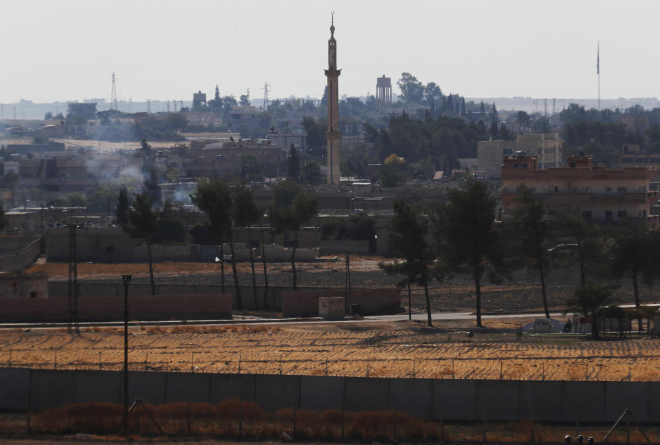 In this photo taken from the Turkish side of the border between Turkey and Syria, in Akcakale, Sanliurfa province, southeastern Turkey, a view of the town of Tal Abyad, Syria, Wednesday, Oct. 23, 2019. Russian media reports say Russian military police have started patrols in northern Syria as a Turkish-Russian agreement giving Syrian Kurdish fighters 150 hours to withdraw from almost the entire northeast border region of Syria came into effect. (AP Photo/Lefteris Pitarakis)