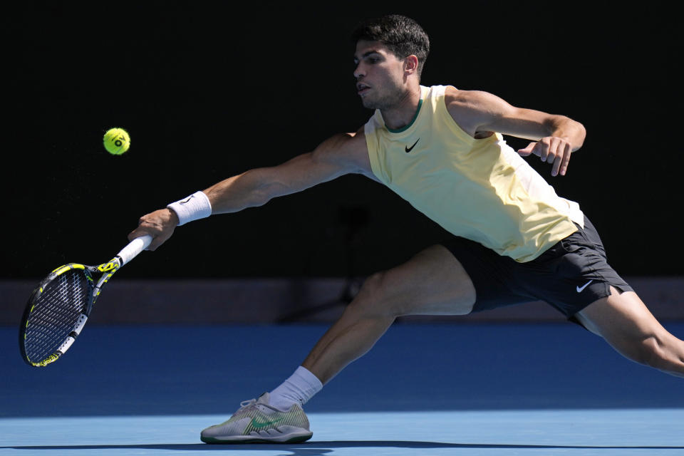 Carlos Alcaraz of Spain plays a forehand return to Shang Juncheng of China during their third round match at the Australian Open tennis championships at Melbourne Park, Melbourne, Australia, Saturday, Jan. 20, 2024. (AP Photo/Andy Wong)