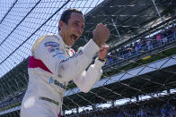 FILE - Helio Castroneves of Brazil celebrates after winning the Indianapolis 500 auto race at Indianapolis Motor Speedway in Indianapolis, Monday, May 31, 2021. Helio Castroneves showed he's still got some lift in his 46-year-old body, climbing the fence after winning a fourth Indy 500. (AP Photo/Paul Sancya)