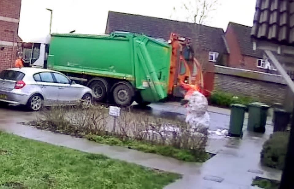 The binman jumped and kicked the snowman as he was passing on his rounds (SWNS) 