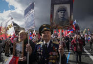 People attend the Immortal Regiment march through Red Square marking the 77th anniversary of the end of World War II, in Moscow, Russia, Monday, May 9, 2022. (AP Photo/Alexander Zemlianichenko)