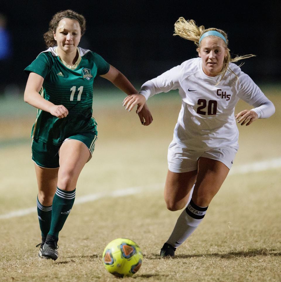 Lincoln's Ava Jones (11) and Chiles' Lauren Wilkey (20) race to take possession of the ball. The Chiles Timberwolves defeated the Lincoln Trojans 2-0 Tuesday, Nov. 30, 2021.