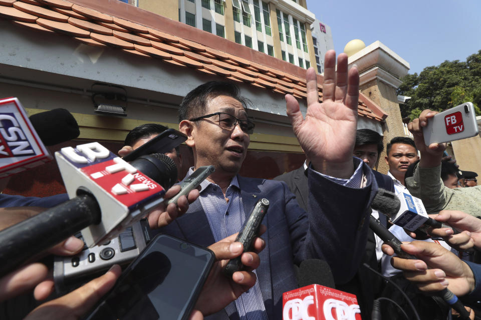 Ky Tech, center, a Cambodian government lawyer, talks with the media in front of a court during a hearing of Kem Sokha, the head of the dissolved Cambodia National Rescue Party, in Phnom Penh, Cambodia Wednesday, Jan. 15, 2020. The trial of the top Cambodian opposition leader charged with treason began Wednesday, more than two years after he was arrested in what is widely seen as a politically motivated prosecution. (AP Photo/Heng Sinith)