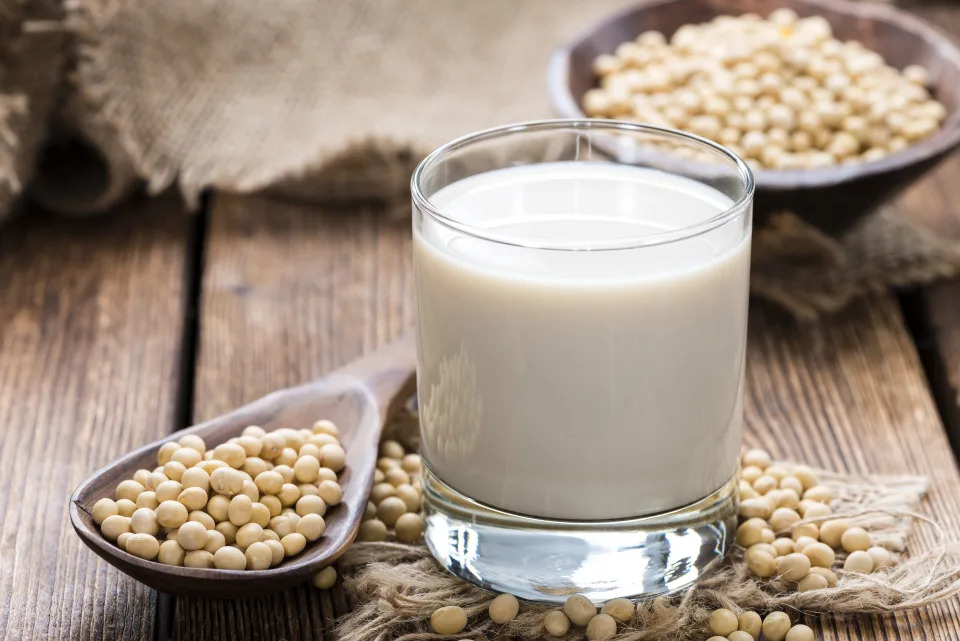 Glass with Soy Milk and Seeds on wooden background