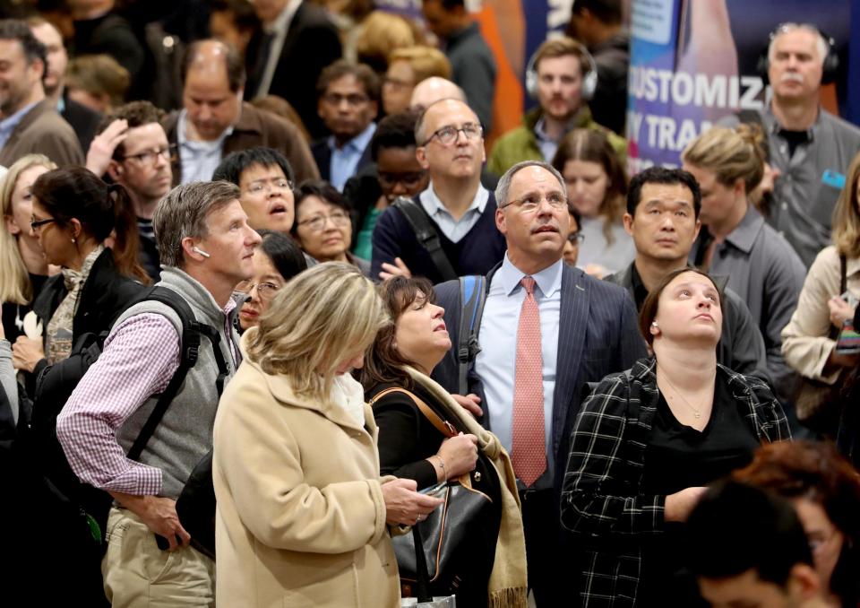 Commuters crowd under train schedule boards in Penn Station waiting to find out what track their homebound train would be departing from during the evening commute Oct. 23, 2019. Once track locations appear on the boards, commuters rush to their gates, with sometimes only minutes to spare before their train leaves the station. 