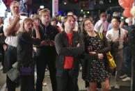 Guests at the election party of Die Linke react at the Karl-Liebknecht-Haus after the publication of the first forecasts on the outcome of the 2021 federal election, in Berlin Sunday, Sept. 26, 2021. Exit polls show the center-left Social Democrats in a very close race with outgoing Chancellor Angela Merkel’s bloc in Germany’s parliamentary election, which will determine who succeeds the longtime leader after 16 years in power. (Jan Woitas/dpa via AP)