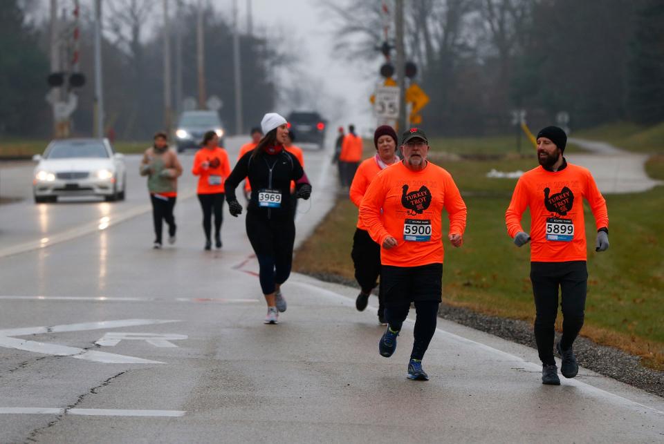 Runners make their way along Barker Road into Foxbrook Park during Kelly Johnson Foundation's first Turkey Trot 5K Run/Walk on Nov. 24, 2018. The Foundation helps make college more affordable for hard working students.