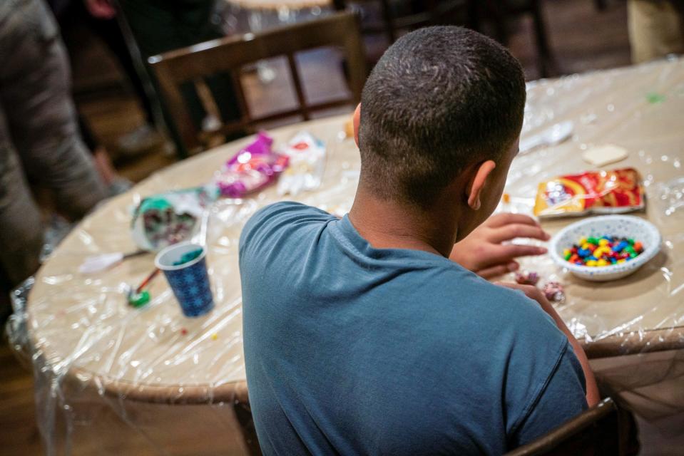 A 13-year-old boy, whose identity is kept anonymous for safety reasons, decorates Christmas cookies at Christ Child House in Detroit on Monday, Dec. 12, 2022.