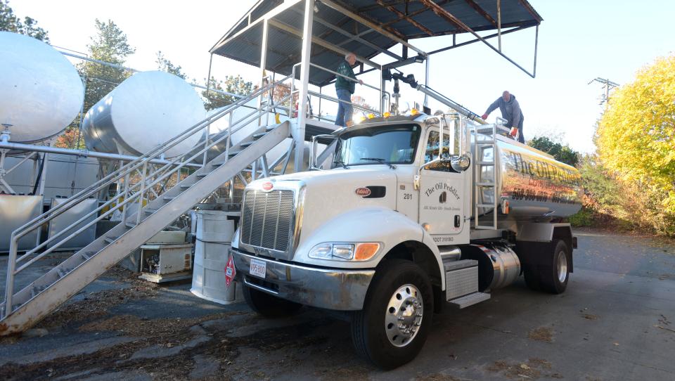 An oil delivery driver for Hall Oil, Gas and Electric in Dennis fills up his truck before heading out for deliveries in 2021. The Massachusetts Department of Public Utilities is eyeing potential improvements to energy affordability programs, to bring down high energy bills.