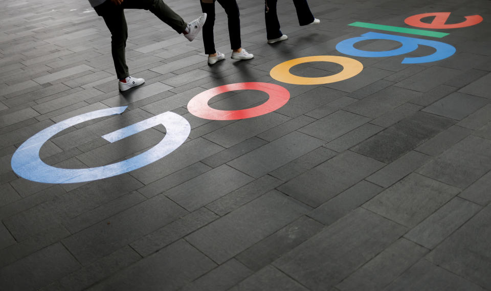 FTSE  Employees pose for photos with a Google logo outside their office, in Singapore August 23, 2022. REUTERS/Edgar Su