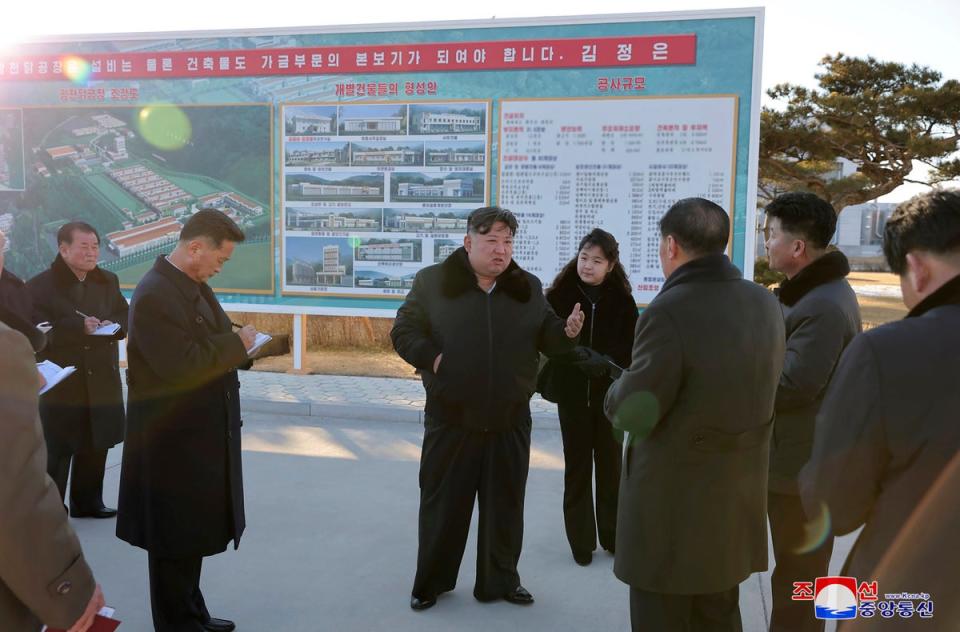 In this photo provided on Monday, 8 January 2024, by the North Korean government, North Korean leader Kim Jong-un, centre, with his daughter visits a newly-built poultry factory in Hwangju County of North Hwanghae Province on 7 January 2024 (KCNA via KNS)