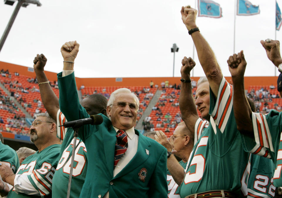 FILE - Former Miami Dolphins coach Don Shula, left, and player Nick Buoniconti, right, celebrate during a halftime ceremony honoring the 1972 perfect season of the Dolphins during an NFL football game against the Baltimore Ravens at Dolphin Stadium, Sunday, Dec. 16, 2007, in Miami. Even though they weren't chasing perfection at the time, they ended up accomplishing something that no team since has repeated. (AP Photo/Lynne Sladky, File)