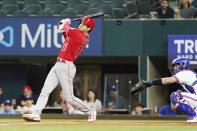 Los Angeles Angels Shohei Ohtani, of Japan, hits a double in front of Texas Rangers catcher Jonah Heim (28) during the first inning of a baseball game in Arlington, Texas, Monday, May 16, 2022. (AP Photo/LM Otero)