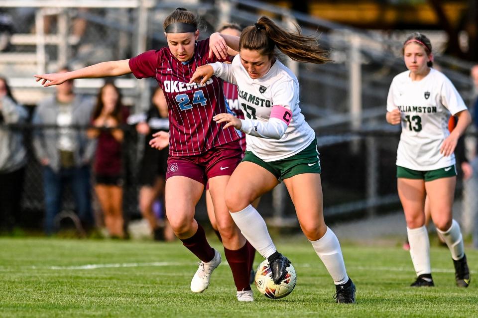 Okemos' Grace Stanley, left, and Williamston's Madi Sesti battle for control of the ball during the first half on Thursday, May 18, 2023, at Okemos High School.