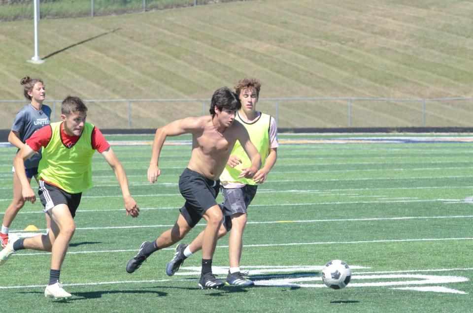 Gaylord's Charlie Holscher pushes ball past defenders during a practice on Tuesday, August 9.