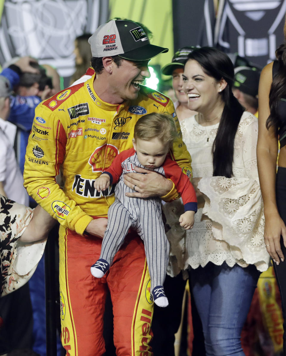 Joey Logano stands with his wife Brittany Baca, as he holds their son Hudson, after winning the NASCAR Cup Series Championship auto race at the Homestead-Miami Speedway, Sunday, Nov. 18, 2018, in Homestead, Fla. (AP)