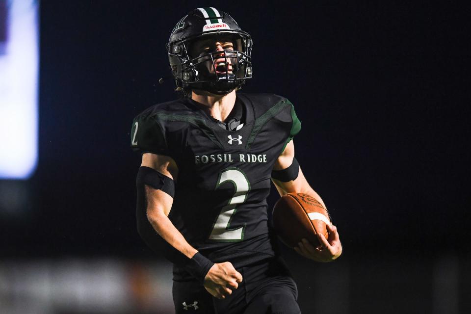 Fossil Ridge's Colton Pawlak (2) celebrates after a touchdown during a high school football game against Windsor at PSD Stadium in Timnath on Thursday. The SaberCats won 35-30.