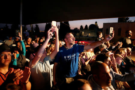 Supporters listen to a pre-recorded message for the U.S. presidential nominee Donald Trump during a convention organised by the Israeli branch of the U.S. Republican party campaigning for Trump, in Jerusalem October 26, 2016. REUTERS/Ammar Awad/File Photo