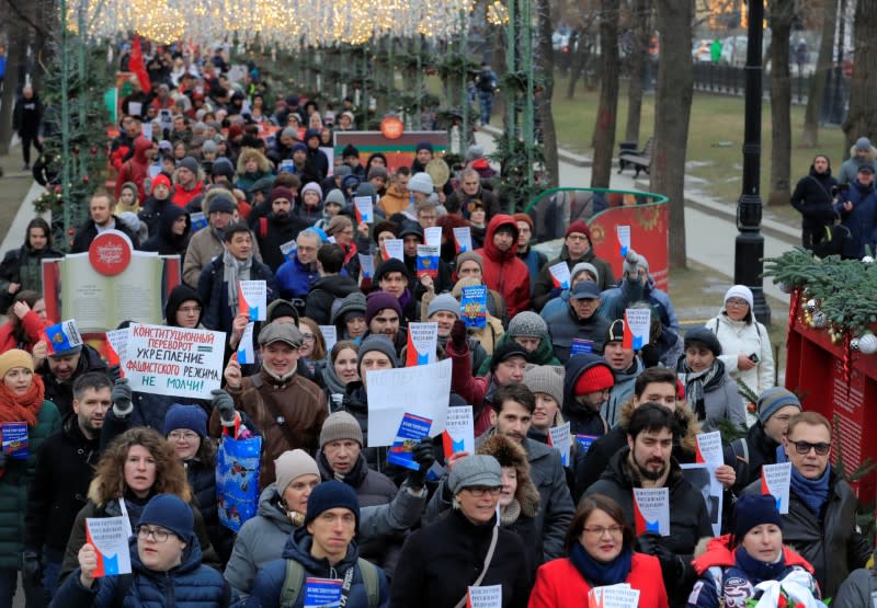 Opposition supporters hold a copies of Russia's constitution during a rally against constitutional reforms proposed by President Vladimir Putin, in Moscow