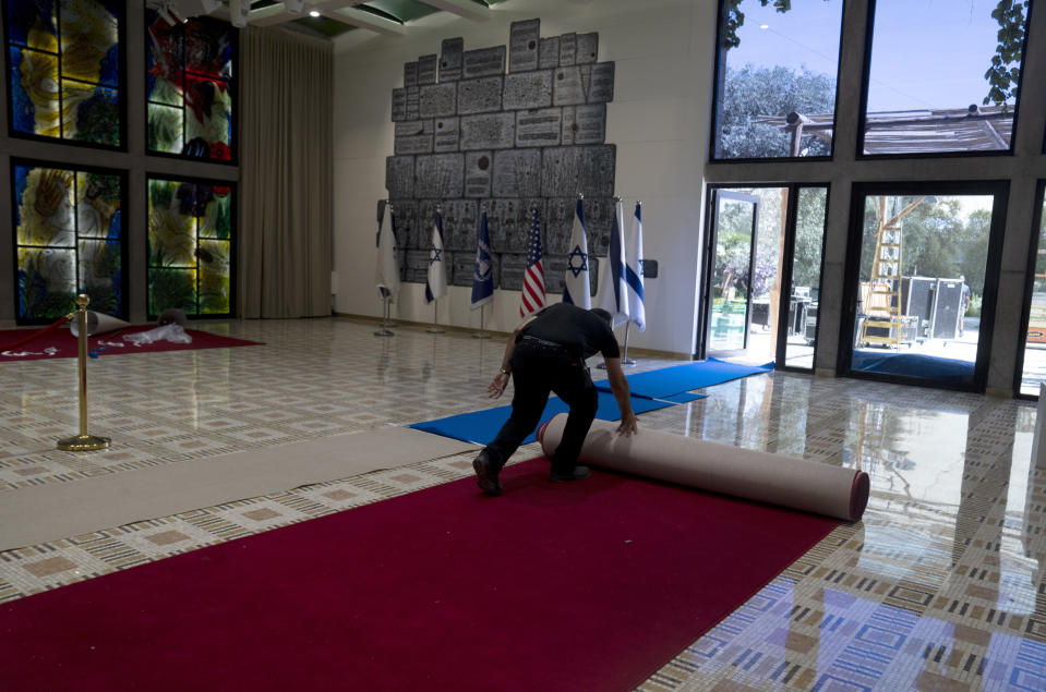 Ronen Sami unrolls red carpet to display for journalists ahead of a visit by U.S. President Joe Biden at the Israeli President's residence in Jerusalem, Monday, July 11, 2022. Biden visits Israel and the occupied West Bank this week for the first time since assuming office. (AP Photo/Maya Alleruzzo)