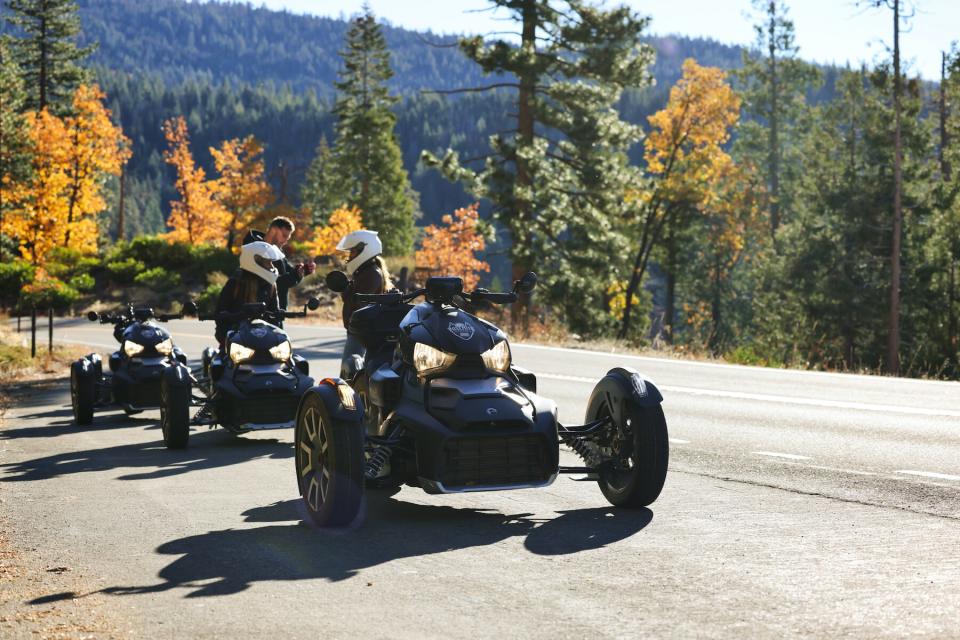 Can-Am motorcycles parked beside fall foliage in Yosemite National Park