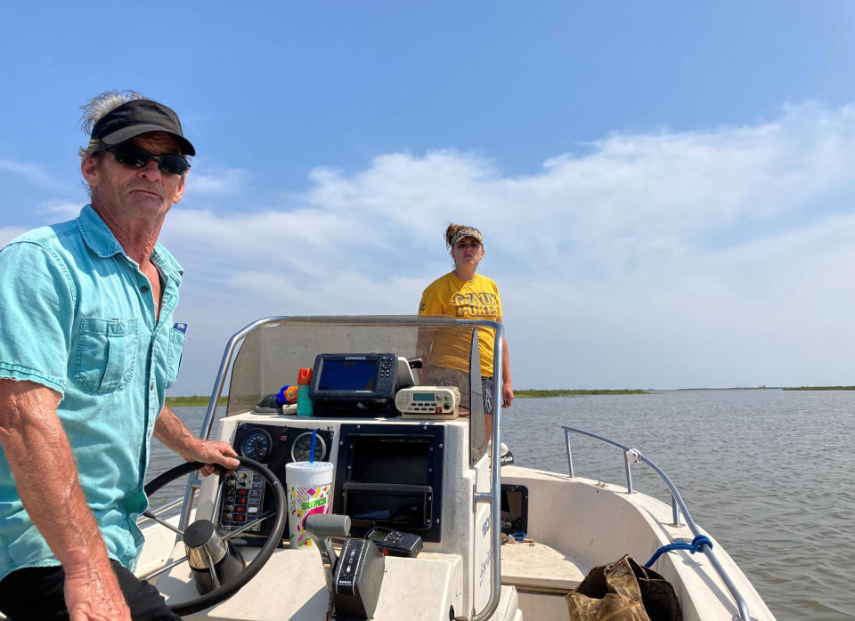 Mike Asher, left, and Chelsea Coleman, right, assist Thursday, April 29, 2021, in the search for survivors who were aboard the Seacor Power, a lift boat that capsized on April 13 off the Louisiana coast. Volunteers have been searching by air and boat for any sign of those still missing. (AP Photo/Rebecca Santana)