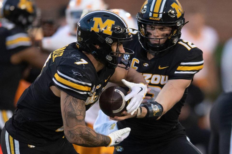 Missouri quarterback Brady Cook (12) hands the ball off to running back Cody Schrader (7) during their NCAA college football game against Tennessee on Saturday, November 11, 2023 in Columbia, MO. Saul Young/News Sentinel/Saul Young/News Sentinel / USA TODAY NETWORK