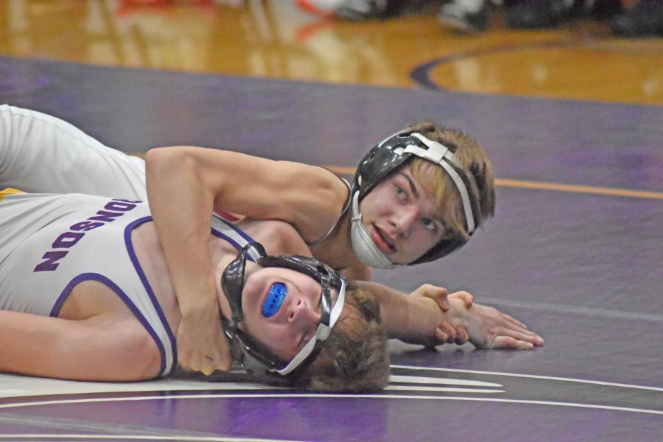 Union City's Mason Hawthorne eyes the referee Wednesday as he posts the arm of Bronson's Owen Kimmons on the way to a pin fall win Wednesday at 120 pounds