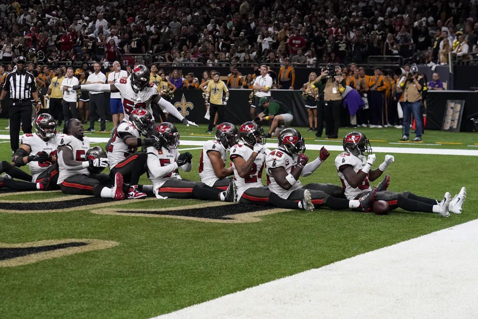 The Tampa Bay Buccaneers celebrates after an interception by cornerback Jamel Dean during the second half of an NFL football game against the New Orleans Saints in New Orleans, Sunday, Sept. 18, 2022. (AP Photo/Gerald Herbert)