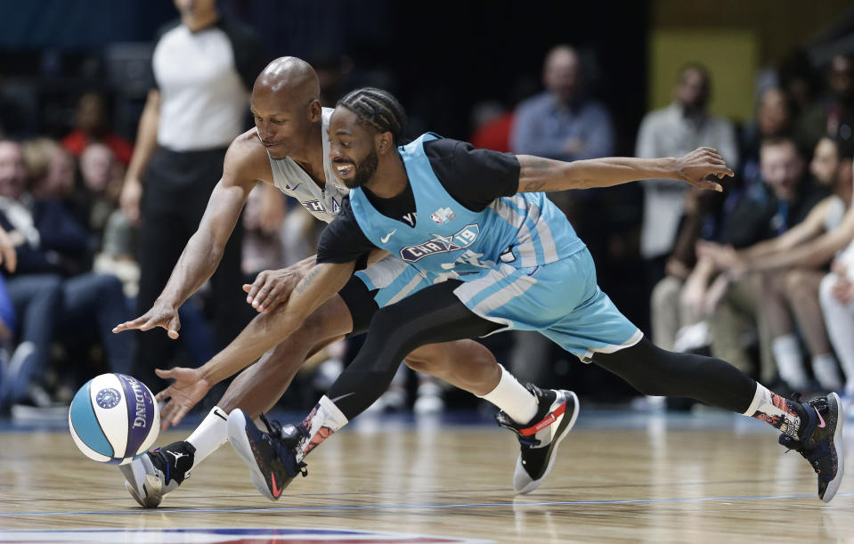 Home team's Famous Los, right, and Away team's Ray Allen chase the ball during the first half of an NBA All-Star Celebrity basketball game in Charlotte, N.C., Friday, Feb. 15, 2019. (AP Photo/Gerry Broome)