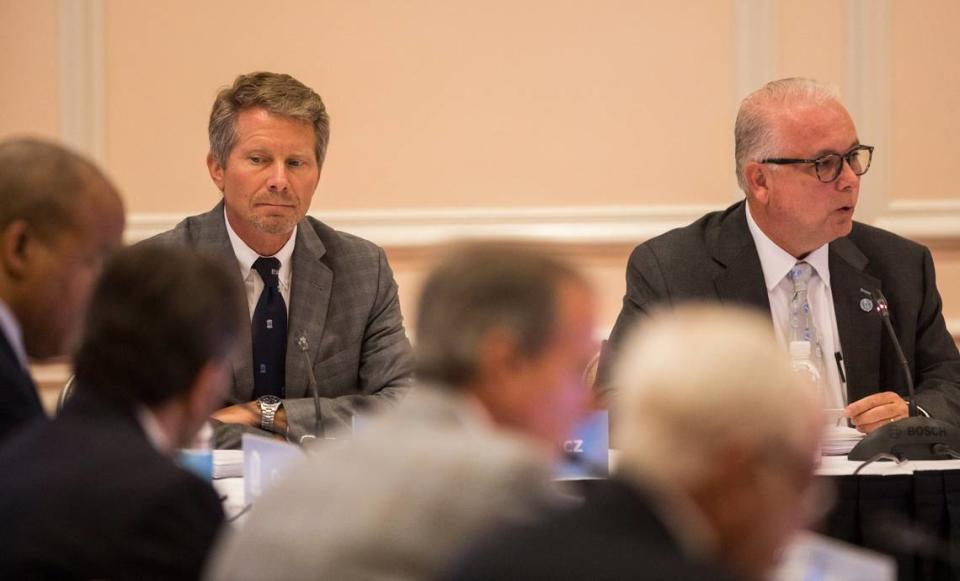 UNC-Chapel Hill Chancellor Kevin Guskiewicz, left, listens as Board of Trustees Chairman Dave Boliek, right, speaks to the board at a July 2021 meeting. Guskiewicz is leaving UNC to become president of Michigan State University. Julia Wall/jwall@newsobserver.com