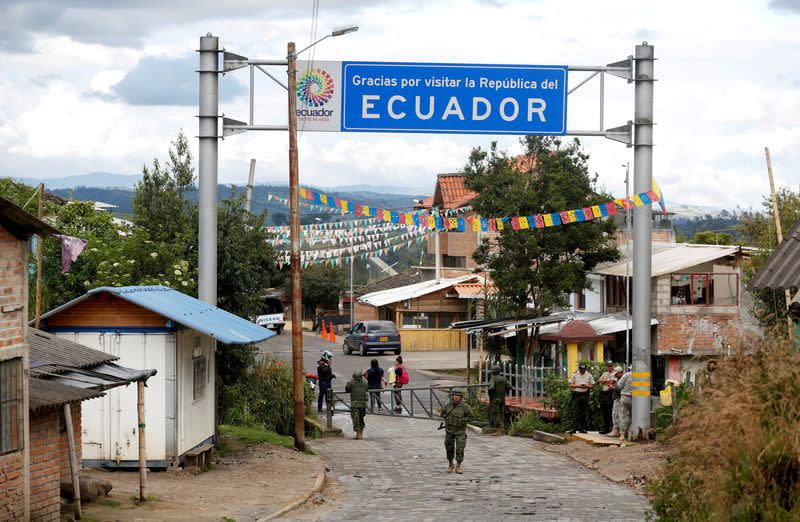 FILE PHOTO: Soldiers stand guard on the Ecuadoran side of a border crossing with Colombia, in Tufino, Ecuador, after Ecuador's government announced the closure of its borders from Sunday to all foreign travelers due to the spread of the coronavirus