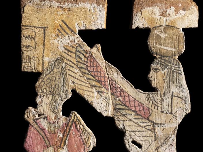 A drawing on crackled cardboard shows an ancient drawing of the winged god Osiris and his wife Isis.