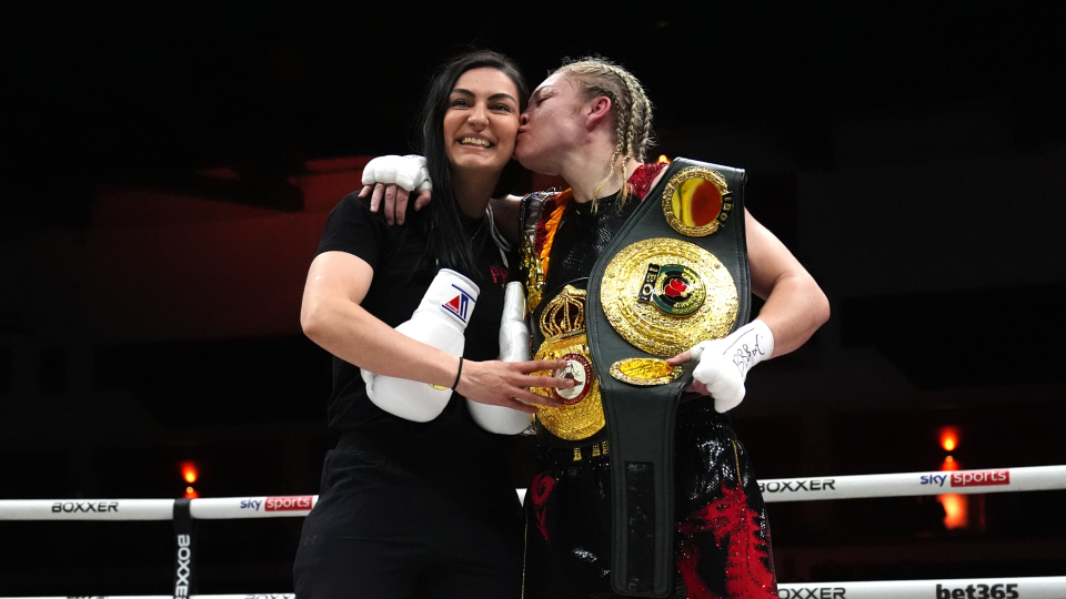 Karriss Artingstall and Lauren Price celebrate with belts following the IBA and WBA World Welter weight bout at Cardiff Utilita Arena. Picture date: Saturday May 11, 2024.
