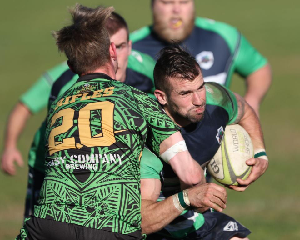 Alex Marquignon (front) powering through a Springfield defender with forwards Pete Logee (behind left) and Sam Frawkins (behind right) in support during the second half of the final against the Springfield Rifles.