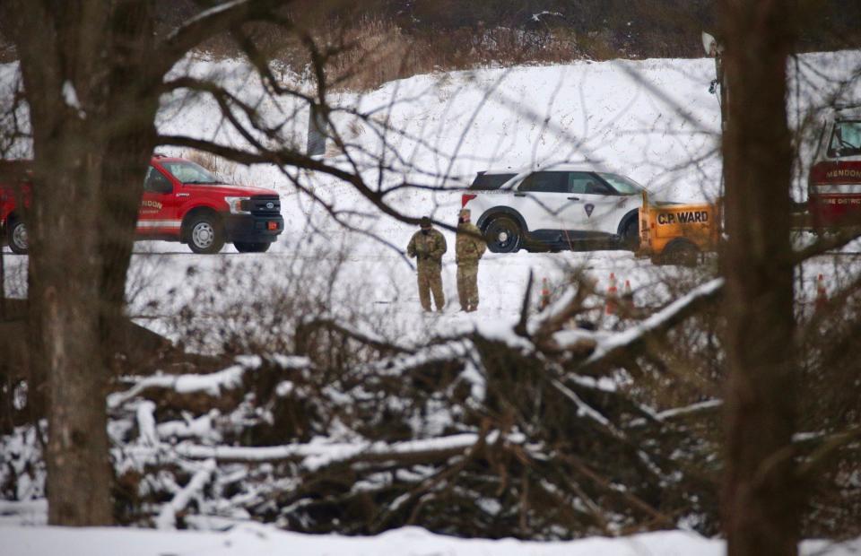 Investigators are shown Thursday, Jan, 21, 2021,  on the scene of a fatal military helicopter crash that occurred Wednesday near West Bloomfield Road in Mendon.