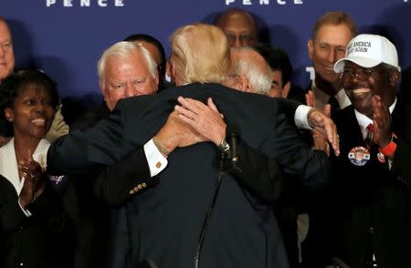 Republican presidential nominee Donald Trump hugs two Medal of Honor recipients before delivering remarks at a campaign event at the Trump International Hotel in Washington, D.C., U.S., September 16, 2016. REUTERS/Mike Segar