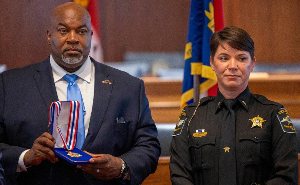 North Carolina Lt. Gov. Mark Robinson presents the North Carolina Medal of Valor to Craven County deputy Lt. Lyndsey Moses-Winnings during a ceremony on Wednesday, July 10, 2024 at the General Assembly in Raleigh, N.C..