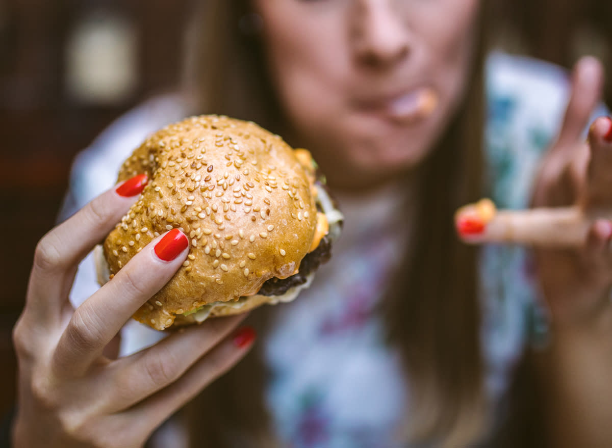 woman eating a hamburger