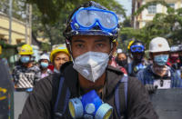 Anti-coup protesters with makeshift shields take positions in Mandalay, Myanmar, Tuesday, March 9, 2021. Demonstrators in Myanmar's biggest city of Yangon came out Monday night for their first mass protests in defiance of an 8 p.m. curfew, seeking to show support for an estimated 200 students trapped by security forces in a small area of one neighborhood. (AP Photo)