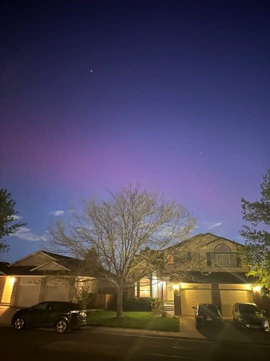 Night sky glows pink over homes