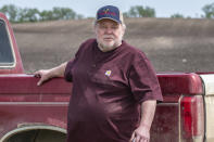 In this photo provided by Farm Rescue, Paul Ivesda watches as volunteers plant crops on his farm June 3, 2020 in Edmore, N.D. The wet spring offered only a tiny window for planting, so when Ivesdal fell ill to a coronavirus infection he knew the timing couldn't be worse. Thanks to Farm Rescue, Ivesdal got his crop in even as he was rushed to a hospital and spend eight days on a ventilator. The nonprofit organization's help meant that although Ivesdal spent a summer in rehabilitation to recover his walking ability and even now tires more easily, he'll be able to keep farming. (Dan Erdmann/Farm Rescue via AP)