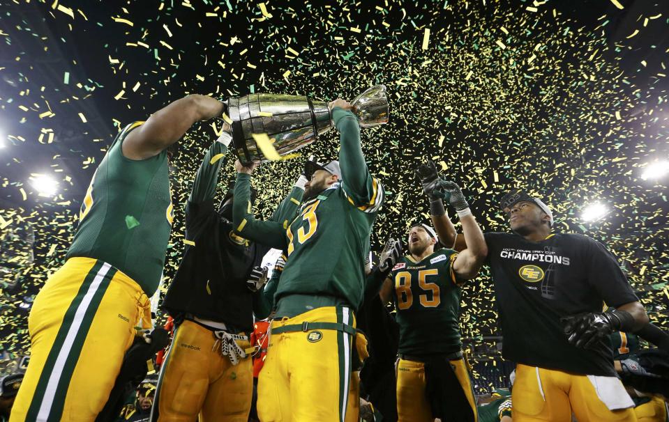 Edmonton Eskimos quarterback Mike Reilly raises the Grey Cup after his team defeated the Ottawa Redblacks in the CFL's 103rd Grey Cup championship football game in Winnipeg, Manitoba, November 29, 2015. REUTERS/Mark Blinch