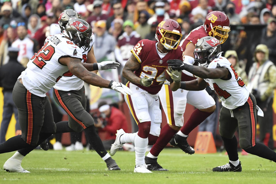 Washington Football Team running back Antonio Gibson (24) runs the ball during the fourth quarter of an NFL football game against the Tampa Bay Buccaneers, Sunday, Nov. 14, 2021, in Landover, Md. (AP Photo/Terrance Williams)