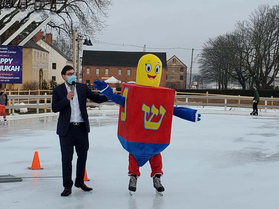 Rabbi Berel Slavaticki of the Seacoast Chabad Jewish Center, dances with a skating dreidel at the Hanukkah party at Strawbery Banke in Portsmouth in 2020.